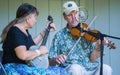 Male and Female Playing a Banjo and Violin